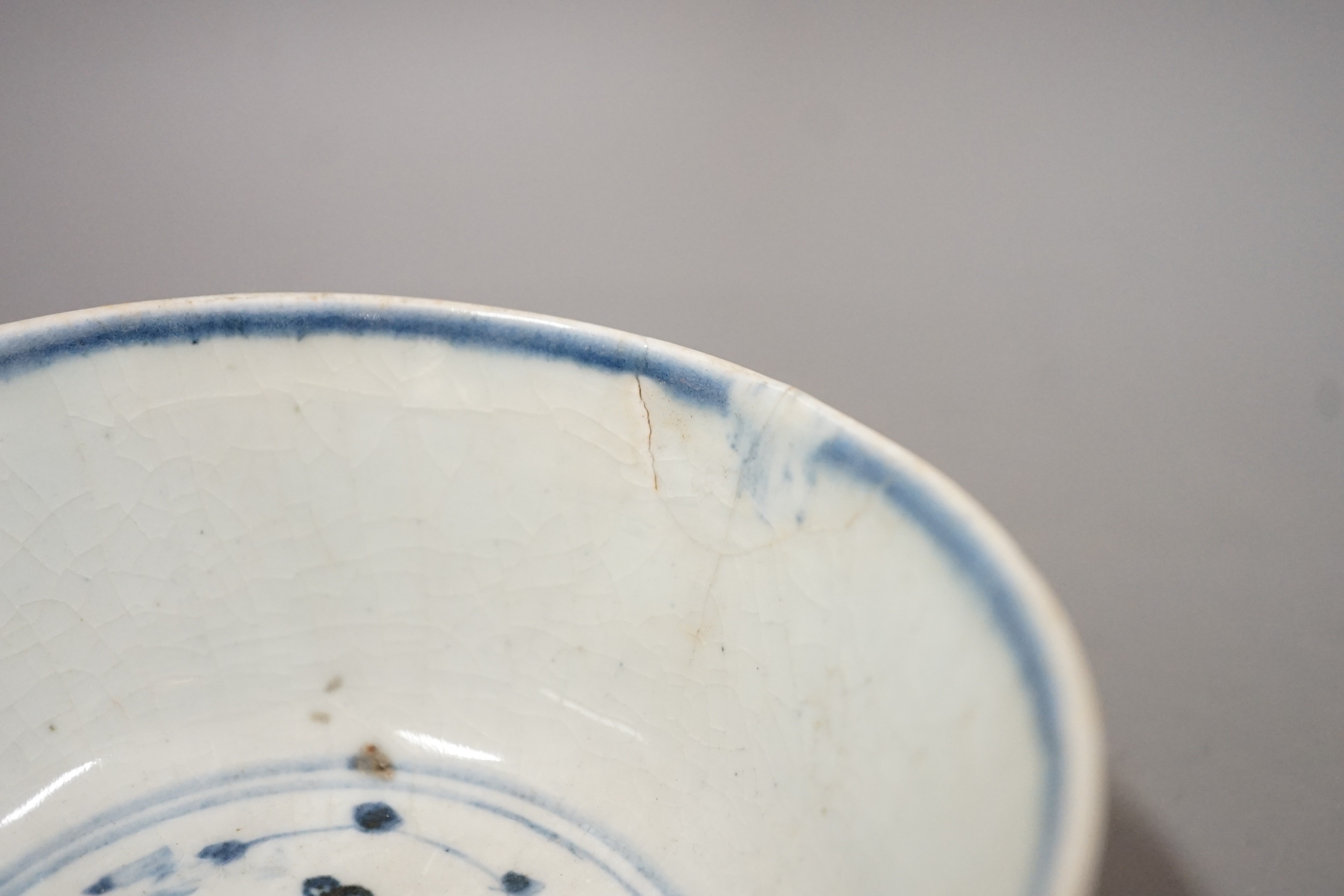 Three Chinese late Ming blue and white bowls, one painted with figures in a boat on horseback and in the landscape, the second with floral sprays, with ‘Made in the Great Ming dynasty’ mark and another bowl, largest 13.3